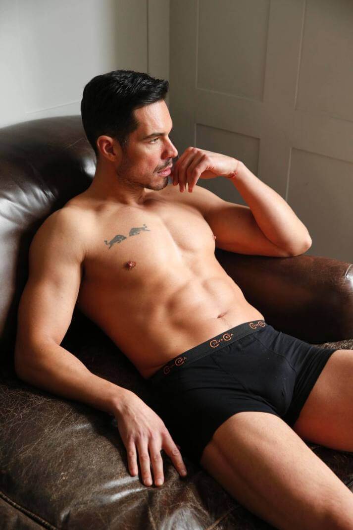 Men sitting on couch in boxer short